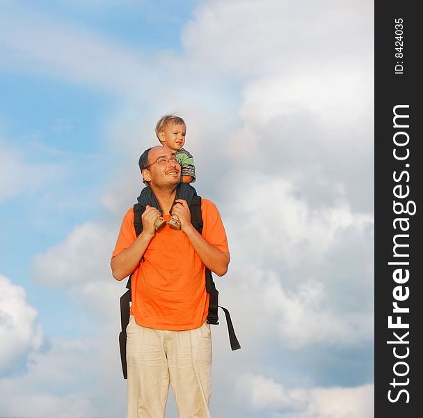 Father and son on sky background