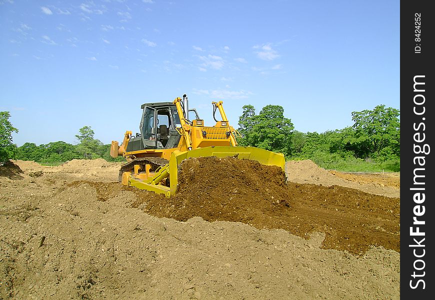 Bulldozer a moving land shovel. Bulldozer a moving land shovel