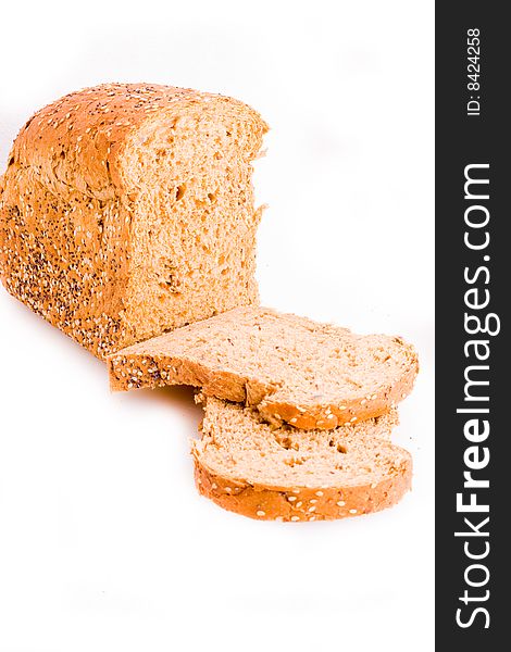 A loaf of wholemeal bread with slices. A loaf of wholemeal bread with slices