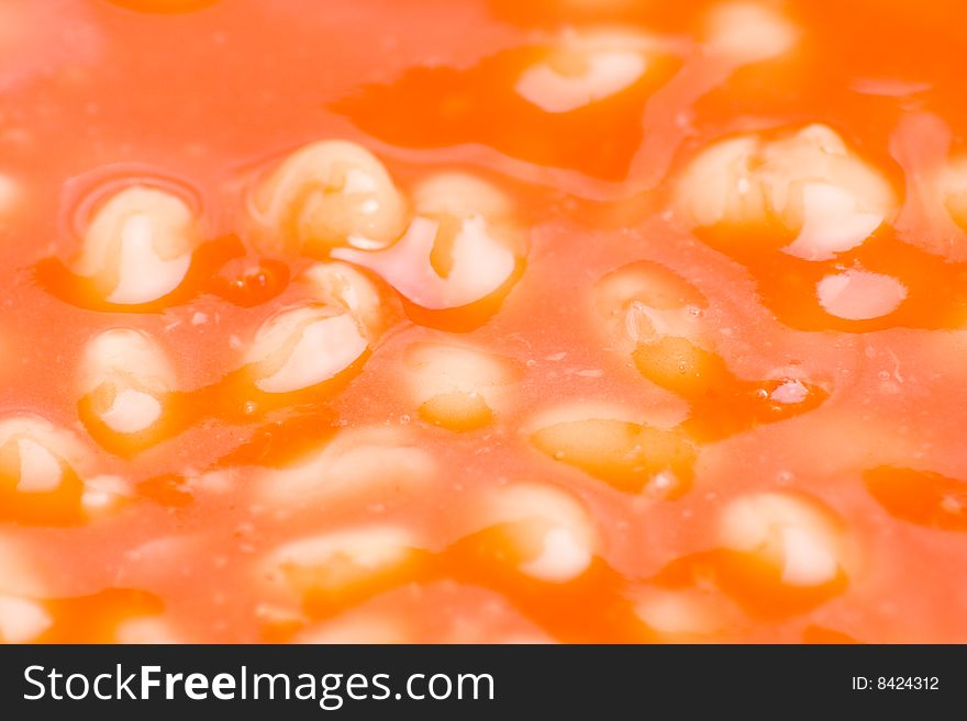 Detail of baked beans in rich tomato sauce. Detail of baked beans in rich tomato sauce