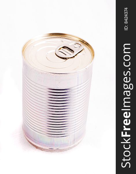 A single unopened tin can over white. A single unopened tin can over white