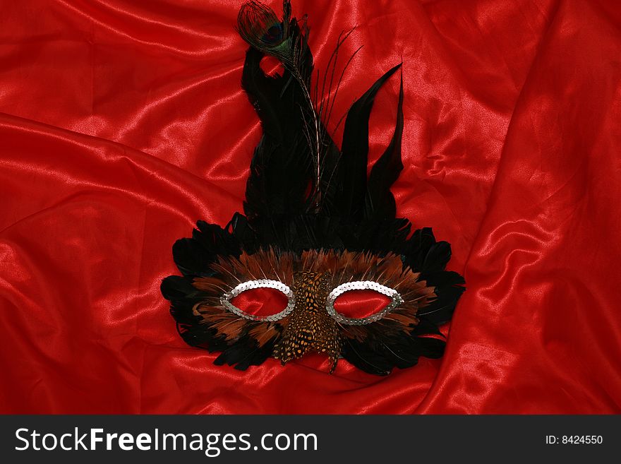 Black mask on red silk