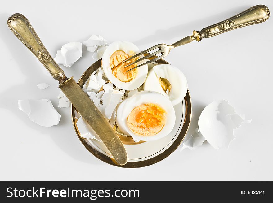 Egg on a white plate with knife and fork. Egg on a white plate with knife and fork