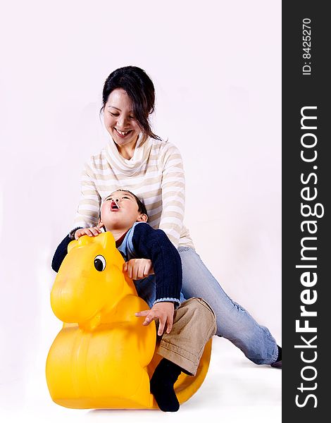 Mother and child riding toy horse