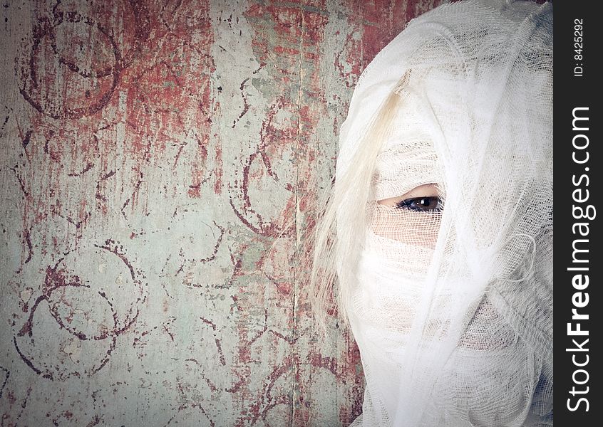 Woman in bandage on the dirty background looking at the camera