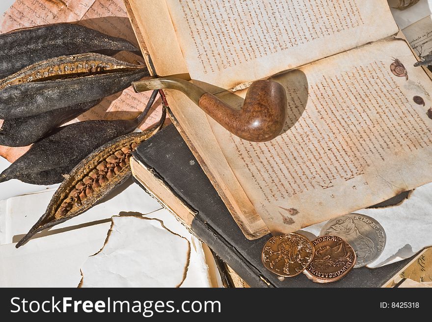 Old ancient book with pipe and old money. Old ancient book with pipe and old money