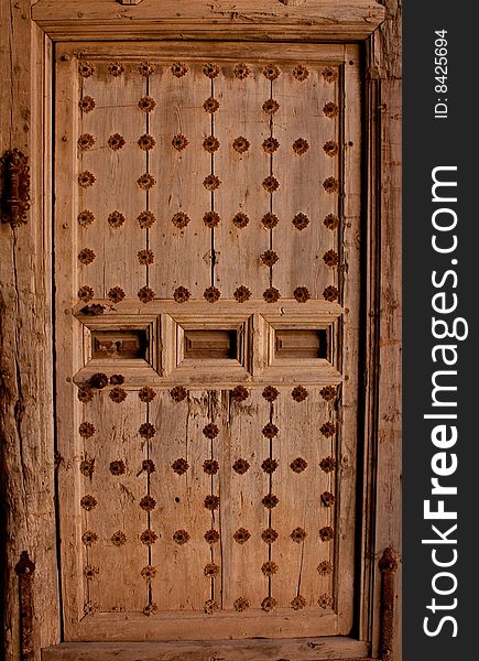Very old wooden door with metal reinforcements. Very old wooden door with metal reinforcements