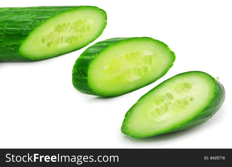 Slices of fresh green cucumber isolated on a white background