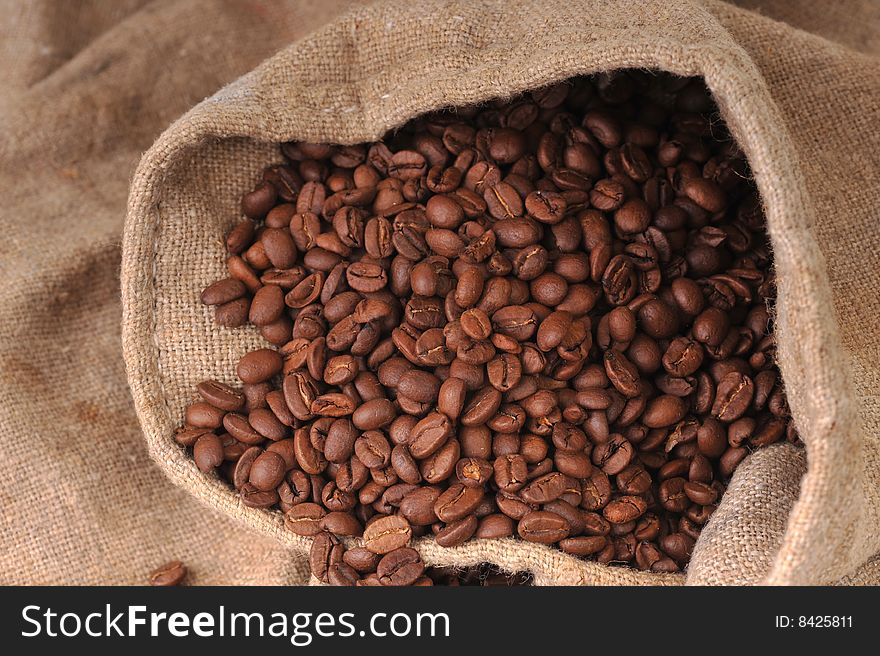 Many coffee grains on rough fabric