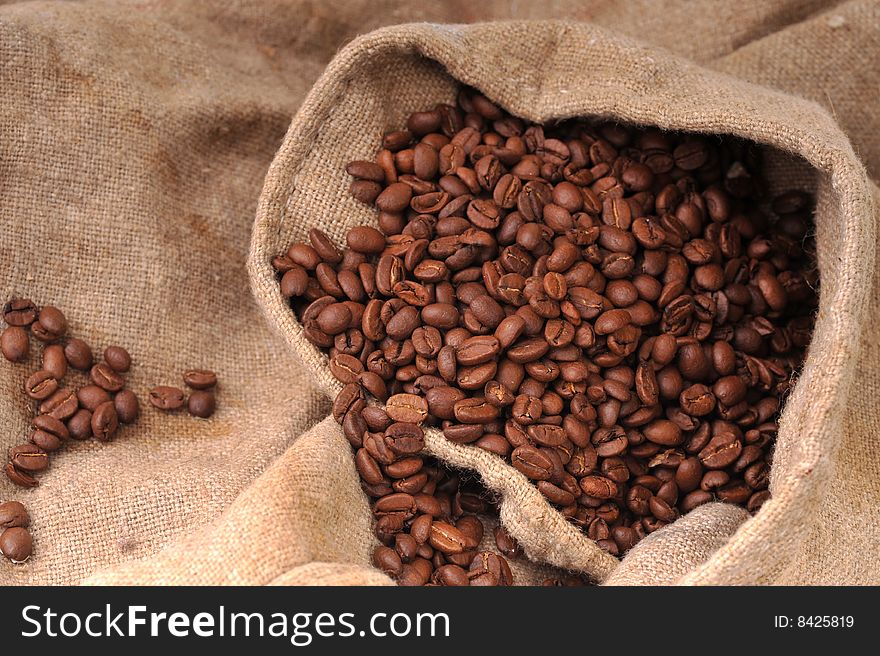 Many coffee grains on rough fabric