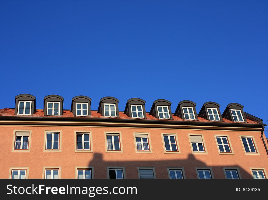 Germany. Munich. Street. The beautiful house on a background of the bright dark blue sky.