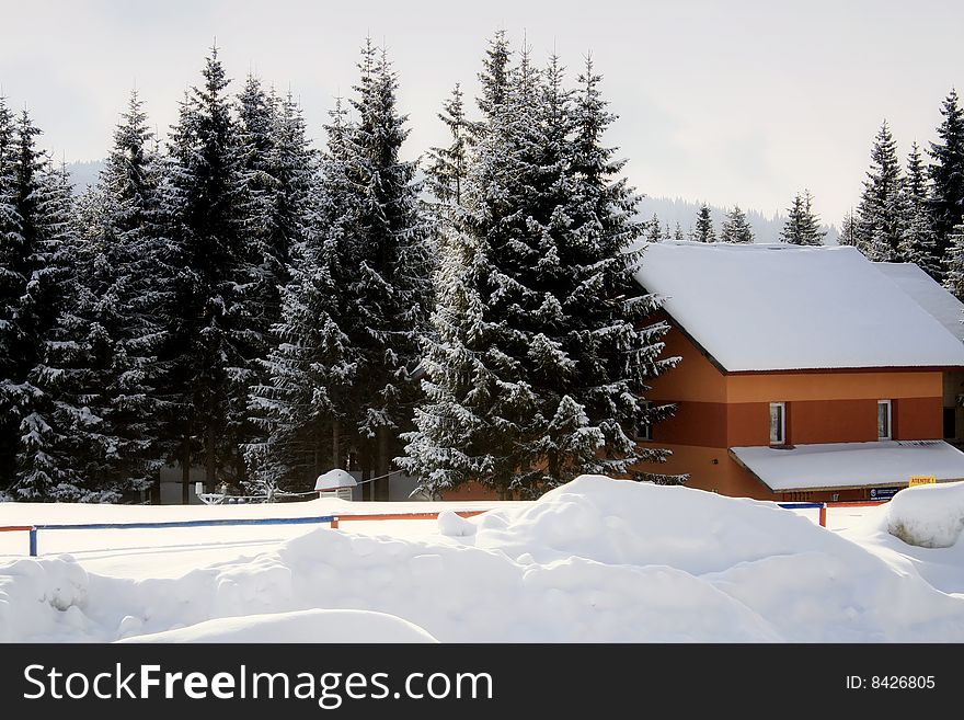 Lodge covered with snow at the sore of Bolboci Lake,Bucegi Mountains. Lodge covered with snow at the sore of Bolboci Lake,Bucegi Mountains