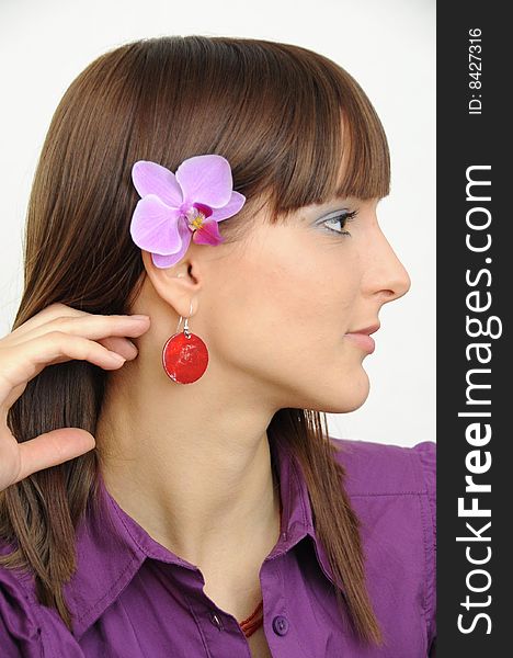 Portrait in profile of a beautiful young girl with flower behind her ear. Portrait in profile of a beautiful young girl with flower behind her ear