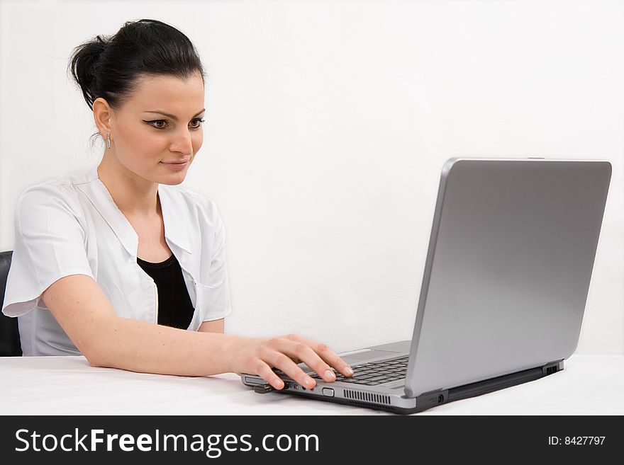 Young doctor is looking the laptop, isolated in white background. Young doctor is looking the laptop, isolated in white background