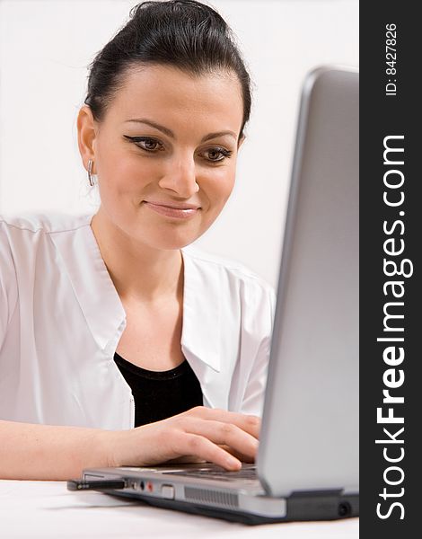 Young doctor is looking the laptop, isolated in white background. Young doctor is looking the laptop, isolated in white background