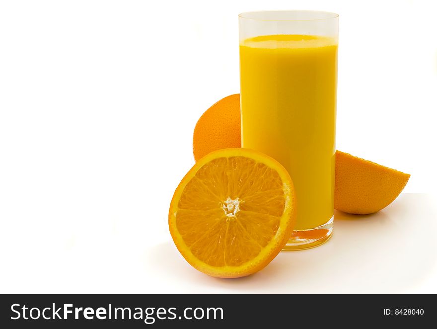 Glass of orange juice and oranges on a white background
