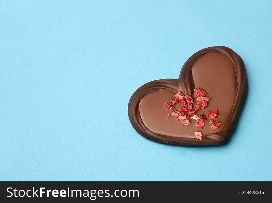 Chocolate heart on the blue background. Chocolate heart on the blue background.