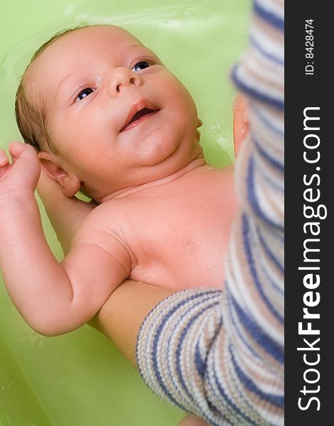 Adorable infant (a boy) in bath - soft focus