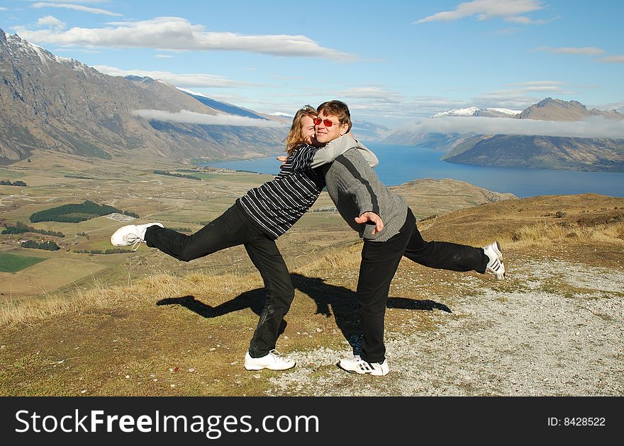 Father and teenage son playing and having fun together in a mountain setting. Father and teenage son playing and having fun together in a mountain setting