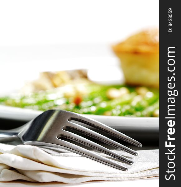 Fork and Fresh Asparagus with Cake Isolated on White Background. Selective Focus. Fork and Fresh Asparagus with Cake Isolated on White Background. Selective Focus