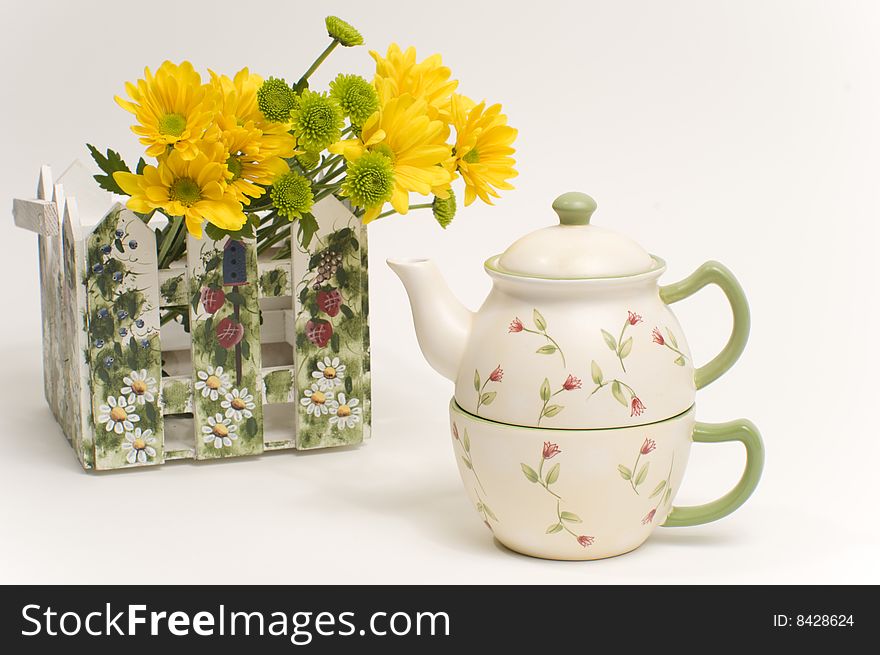 Teapot Next To Bouquet Of Yellow Flowers