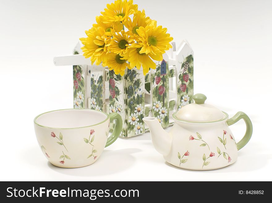 Teapot and cup with yellow flowers