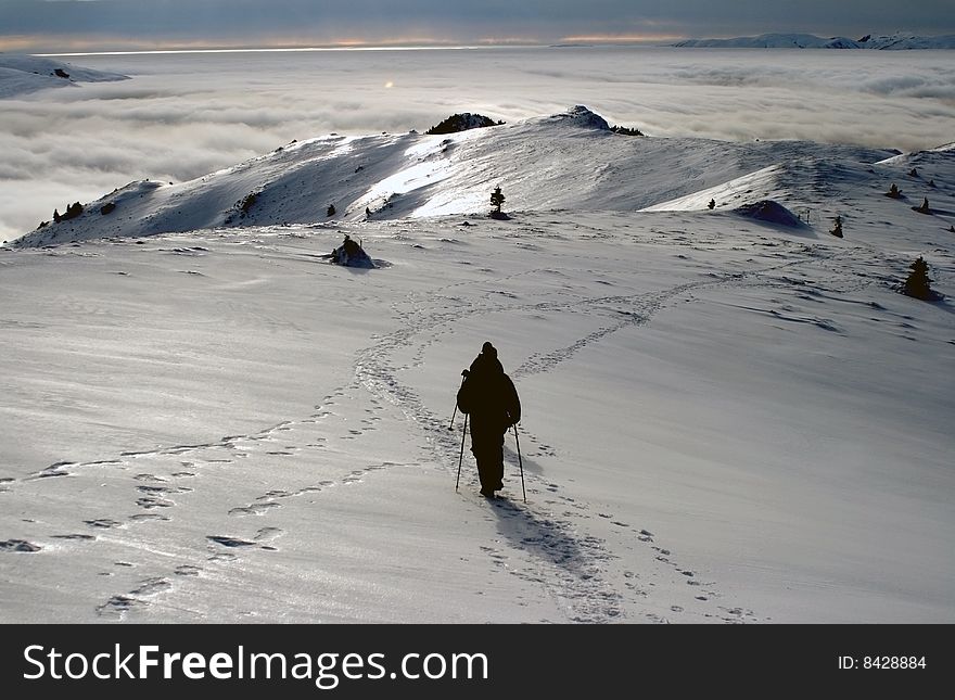 Silhouettes hiking on the top of a romanian mountain, Ciucas, and walking towards the horizon. Silhouettes hiking on the top of a romanian mountain, Ciucas, and walking towards the horizon.