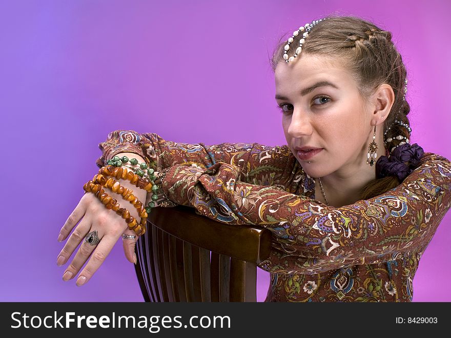 Nice young belly-dancer in ethnic indian dress against violet background. Nice young belly-dancer in ethnic indian dress against violet background