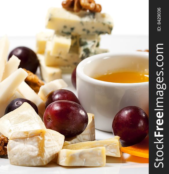Various Types of Cheese with Honey Sauce and Grapes. Various Types of Cheese with Honey Sauce and Grapes