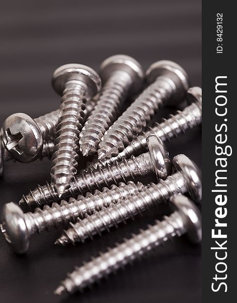 Pile of silver colored construction screws. Pile of silver colored construction screws