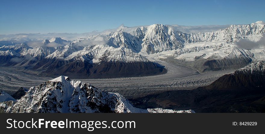 An Alaskan Glacier with mountains in the backround.