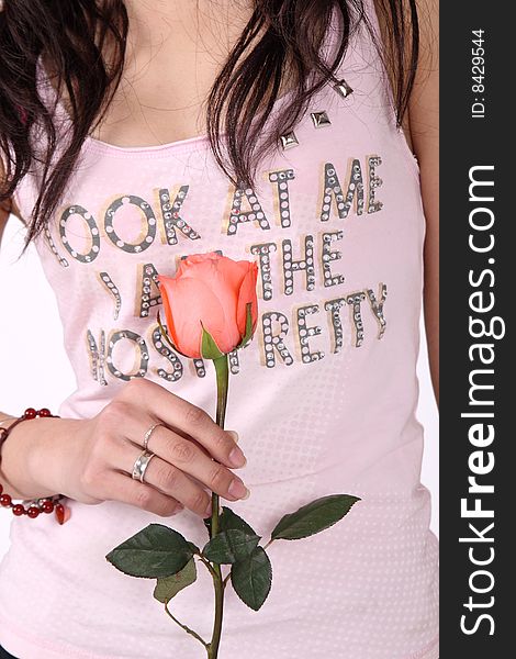 A girl holds a pink rose. A girl holds a pink rose.