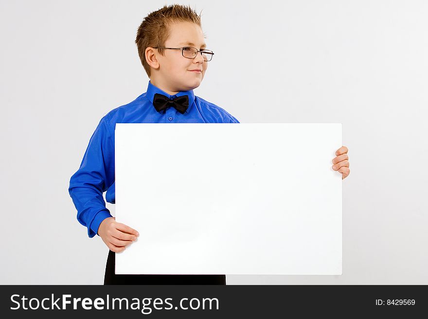 Young well-dressed boy holding an empty advertising card. Young well-dressed boy holding an empty advertising card