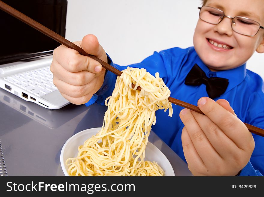 Hungry fat boy eating chinese noodles with sticks