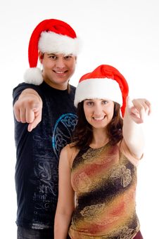Pointing Couple Wearing Christmas Hat Stock Photography Pointing Couple Wearing Christmas Hat Stock Photography
