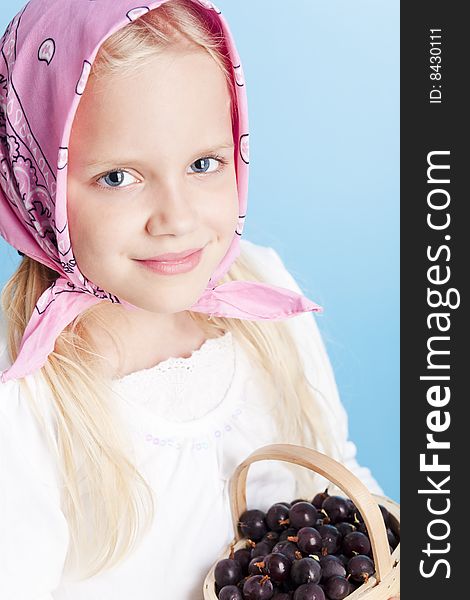 Young country girl with basket filled with berries