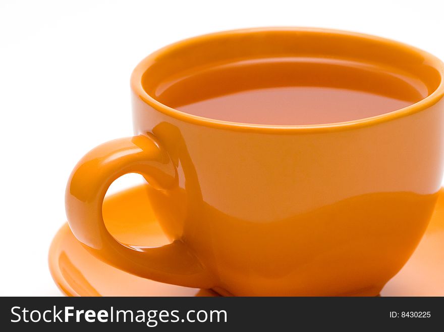 Orange cup of tea on white background.