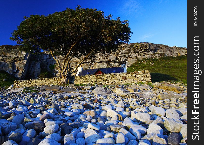 Isolated cottage and a tree at port elgol at twilight, scotland. Isolated cottage and a tree at port elgol at twilight, scotland