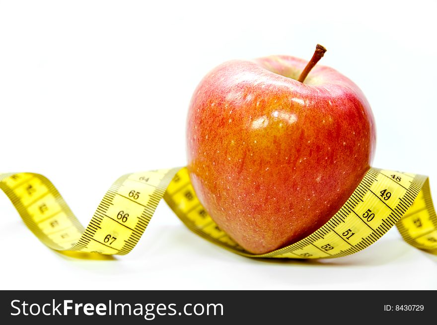 Apple with measuring tape as a symbol for dieting