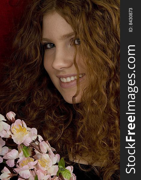 Red haired teenager with red roses, attractive youthful with long hair