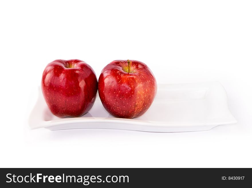 Ripe red apple and plate on white