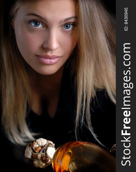 Portrait of a girl on a dark background with objects