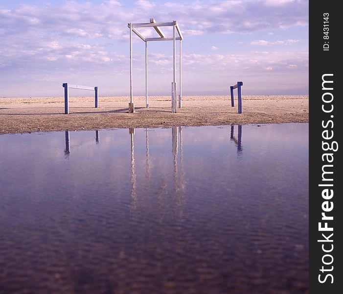 Wooden structure reflecting in water by the beach. Wooden structure reflecting in water by the beach.