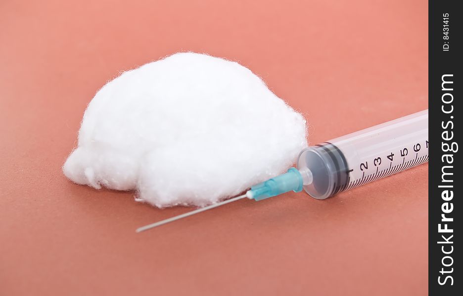 Cotton and syringe photograph in the foreground