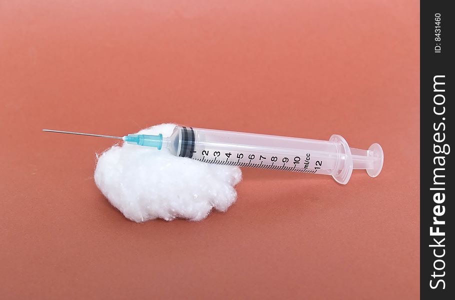 Cotton and syringe photograph in the foreground