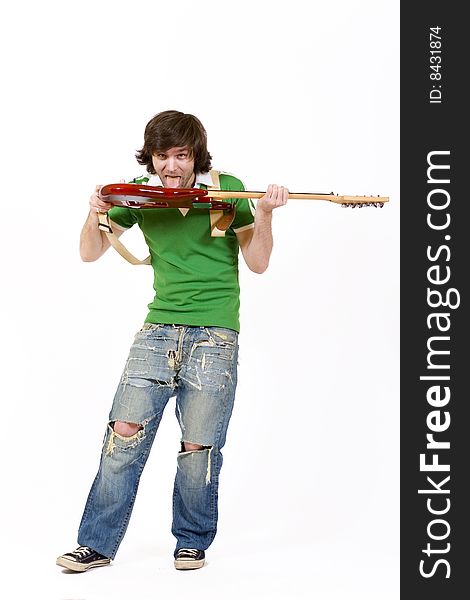 Guitarist biting the guitar over white background. Guitarist biting the guitar over white background