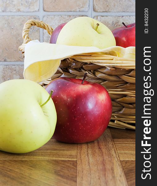Rustic photo of apples in a wicker basket and next to it