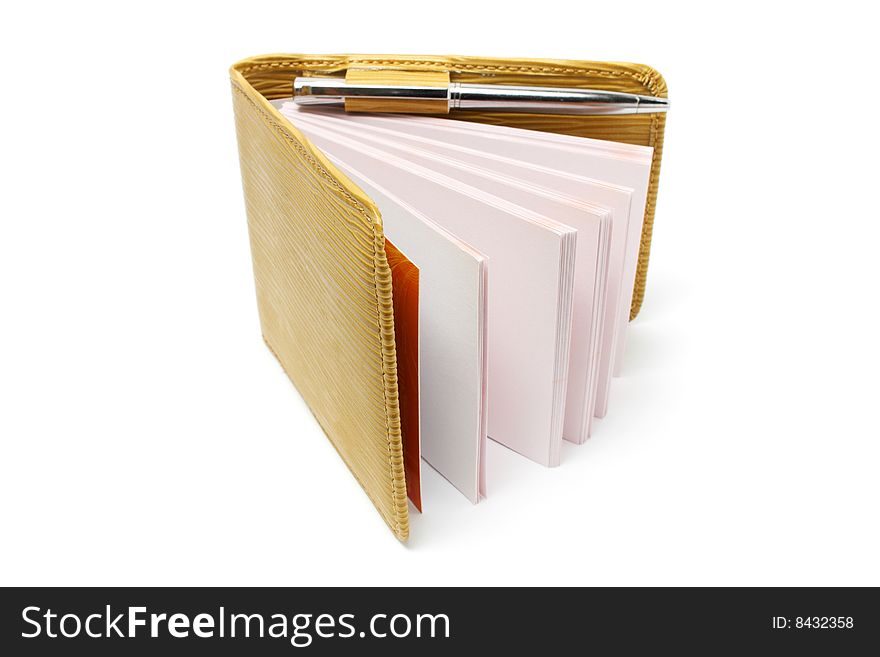 A small notebook with beige cover isolated on white background. A small notebook with beige cover isolated on white background.