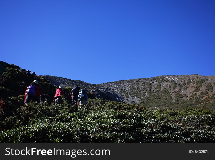 People with backpack trekking along the mountain