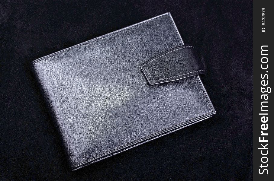 Leather wallet on black.